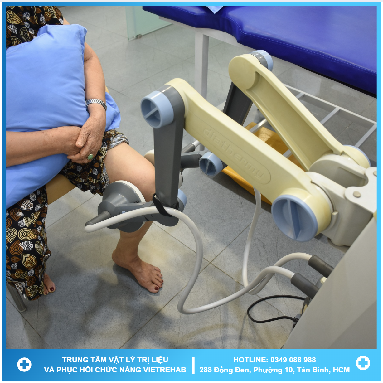 A therapist working with a patient on a rehabilitation machine with greenery in the background